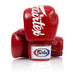 A pair of red Fairtex boxing gloves with the brand logo in white on the cuffs, designed for tight-fitting and compact use.