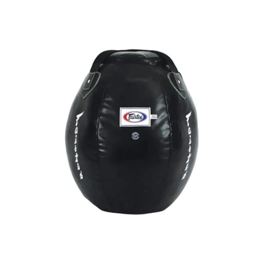 A black leather punching bag with a central Fairtex logo patch and white vertical branding text on both sides, photographed on a clean white background.