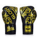 Pair of black and gold boxing gloves with 'Glorory' branding on a white background