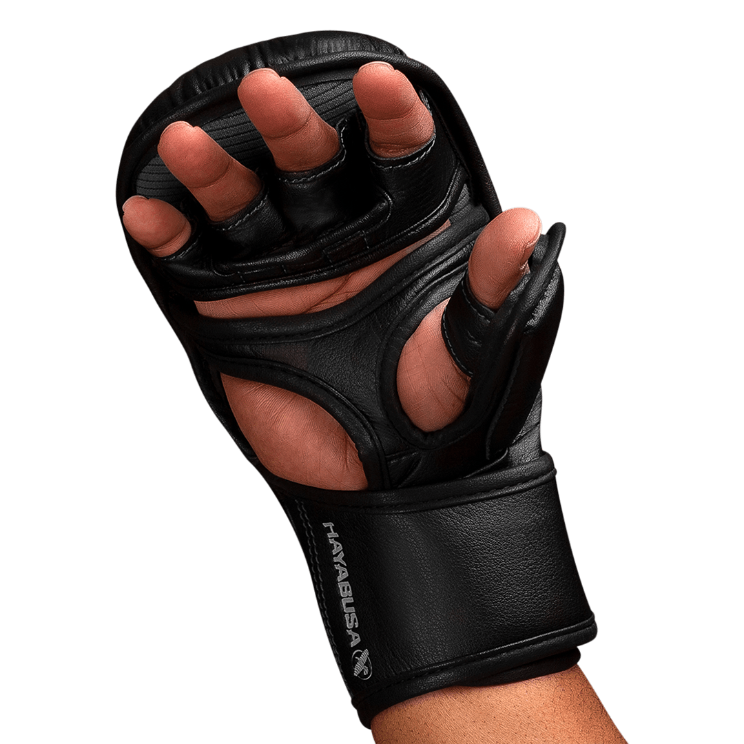 Black martial arts glove on a hand with a black background