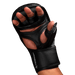 Black martial arts glove on a hand with a black background